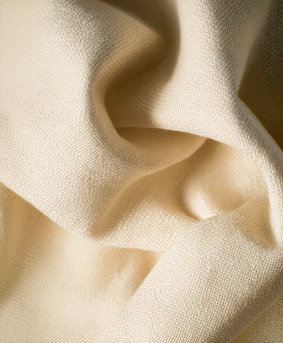 Close-up van ademende beige katoenen stof voor babyproducten